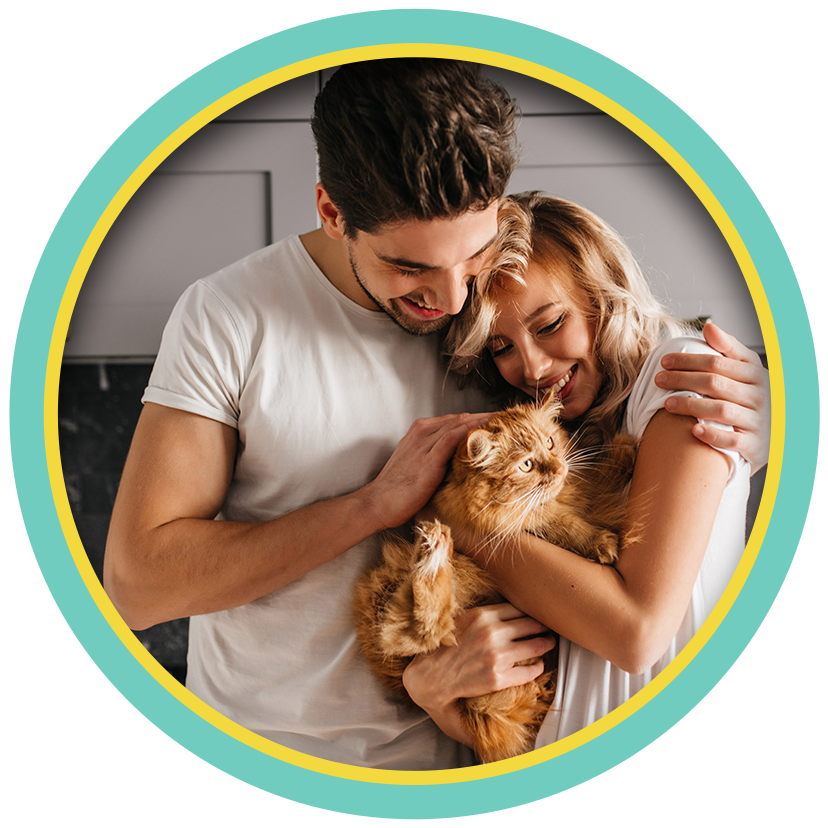 Smiling couple cuddling a fluffy orange cat in a circular frame.