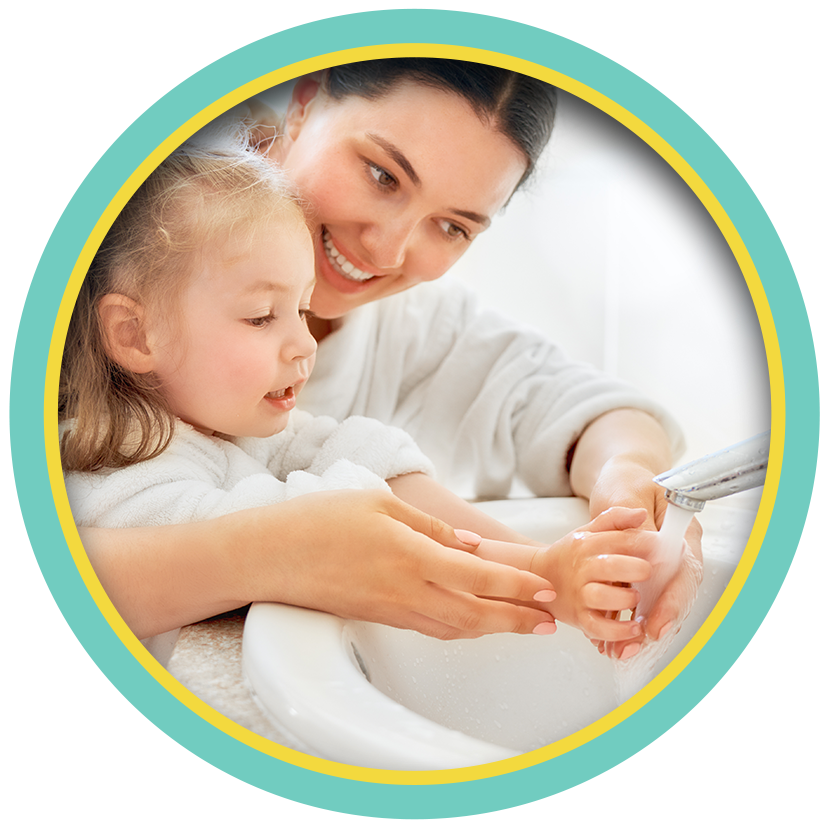 Mother helping toddler wash hands at a sink in a circular photo frame
