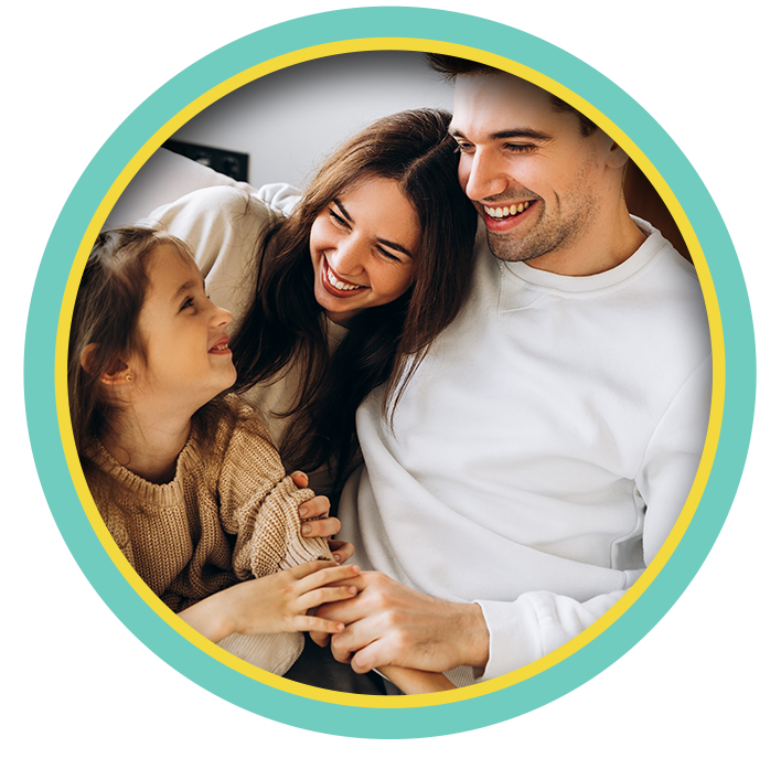 Smiling family of three in a circular frame with a teal and yellow border