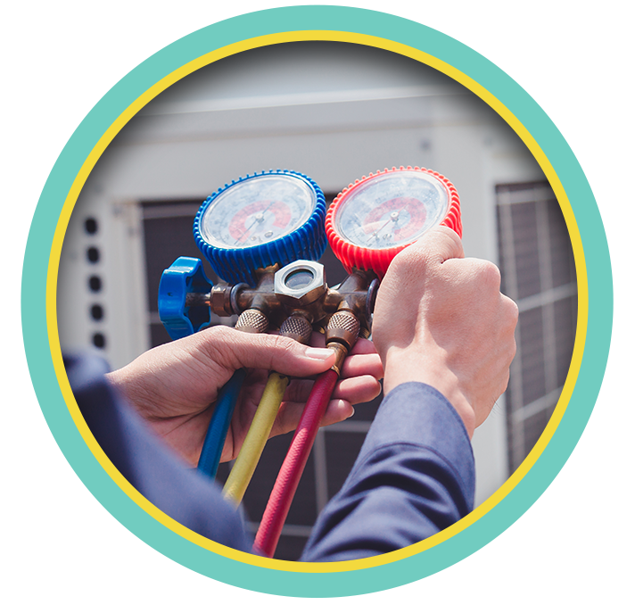 Technician checking HVAC gauges with red and blue hoses