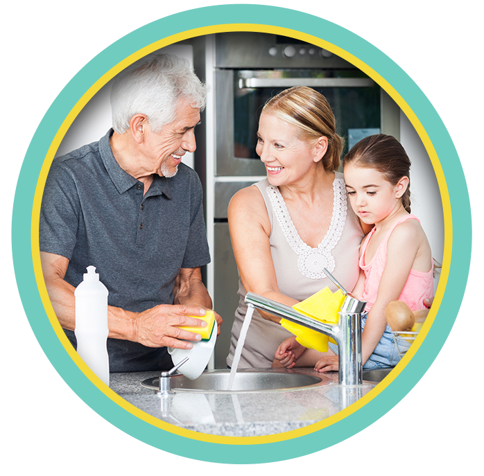 Smiling family in a kitchen, sharing a meal preparation together.